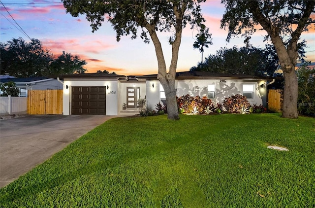 8848 Sunlit Cove Dr NE, Saint Petersburg, FL 33702 - view of front of home with stucco siding, concrete driveway, and a garage