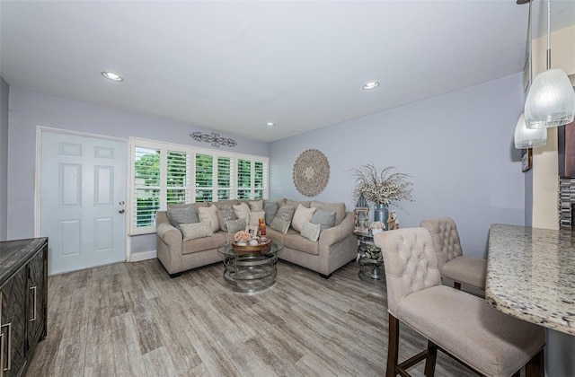 5694 40th Ter N Unit 423, Kenneth City, FL 33709 - living area with light wood finished floors, recessed lighting, and baseboards