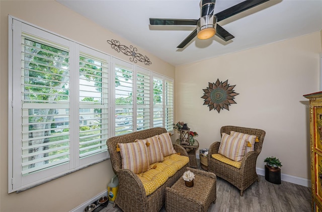 5694 40th Ter N Unit 423, Kenneth City, FL 33709 - sitting room with wood finished floors, a ceiling fan, and baseboards
