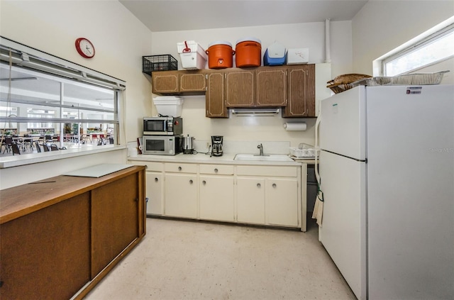 5694 40th Ter N Unit 423, Kenneth City, FL 33709 - kitchen with freestanding refrigerator, stainless steel microwave, a sink, and light countertops