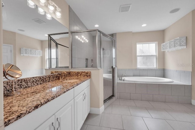 bathroom featuring a shower stall, a bath, tile patterned flooring, and vanity
