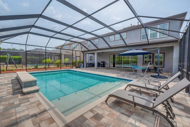 view of swimming pool featuring a patio area and a lanai