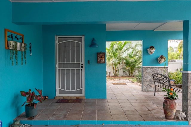 854 77th Ave N, Saint Petersburg, FL 33702 - property entrance featuring stucco siding and a patio area