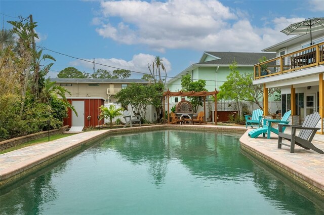 854 77th Ave N, Saint Petersburg, FL 33702 - view of pool featuring fence, a patio, a storage unit, and an outbuilding