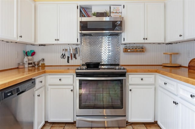 854 77th Ave N, Saint Petersburg, FL 33702 - kitchen with stainless steel appliances, light countertops, white cabinets, and tasteful backsplash