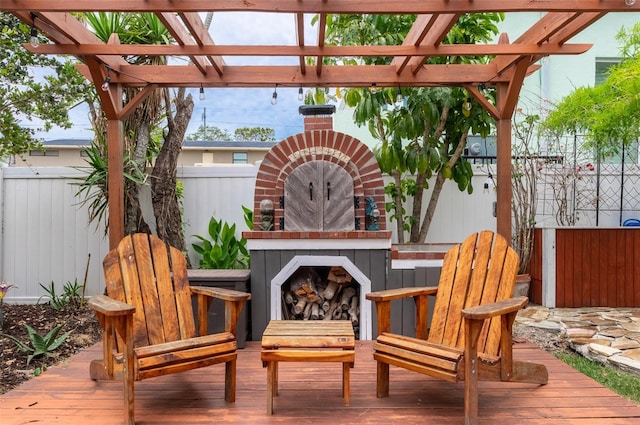 854 77th Ave N, Saint Petersburg, FL 33702 - deck featuring an outdoor brick fireplace, fence, and a pergola