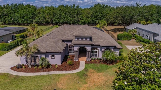 5507 Keeler Oak St, Lithia, FL 33547 - view of front of house featuring a front lawn, stucco siding, concrete driveway, and roof with shingles