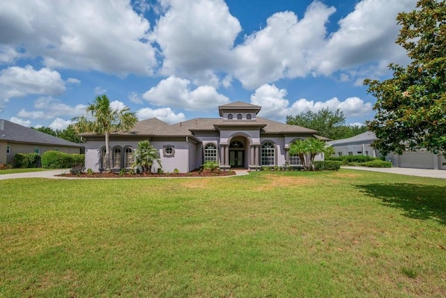 5507 Keeler Oak St, Lithia, FL 33547 - mediterranean / spanish-style house featuring stucco siding, a front lawn, french doors, and roof with shingles