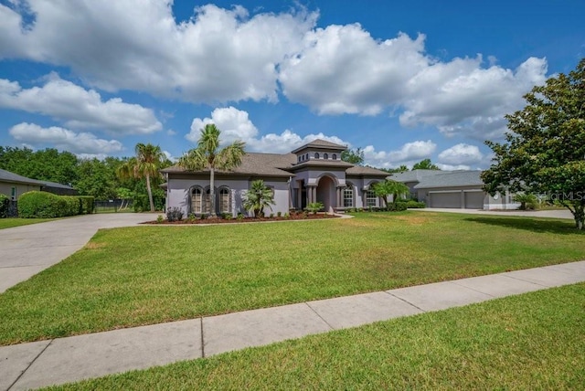 5507 Keeler Oak St, Lithia, FL 33547 - mediterranean / spanish home featuring concrete driveway, a front yard, and stucco siding