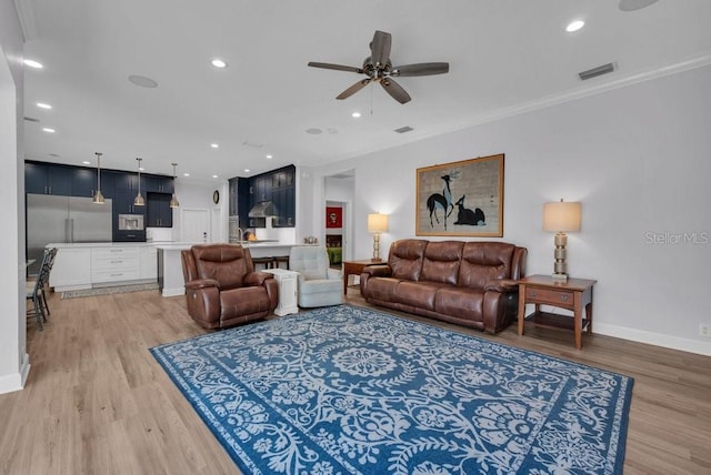 5507 Keeler Oak St, Lithia, FL 33547 - living area with light wood finished floors, a ceiling fan, recessed lighting, and crown molding