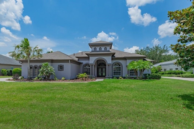 5507 Keeler Oak St, Lithia, FL 33547 - mediterranean / spanish house with french doors, a front lawn, and stucco siding