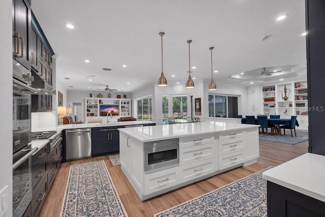 5507 Keeler Oak St, Lithia, FL 33547 - kitchen featuring stainless steel appliances, ceiling fan, light countertops, recessed lighting, and light wood-style floors