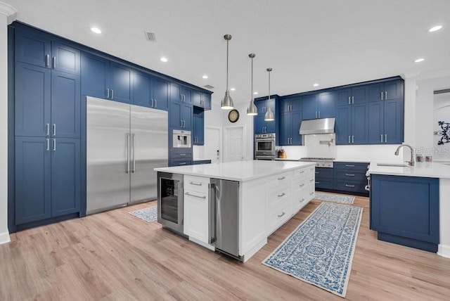 5507 Keeler Oak St, Lithia, FL 33547 - kitchen featuring stainless steel appliances, wine cooler, under cabinet range hood, light wood-style flooring, and recessed lighting