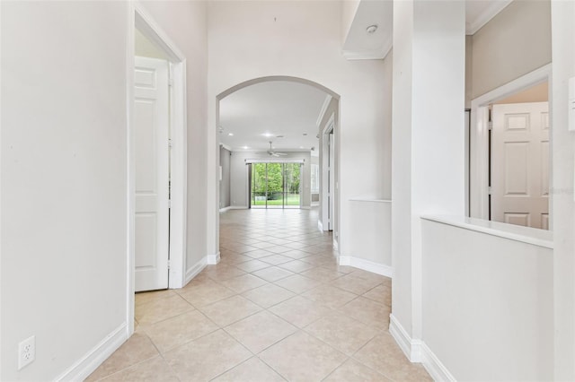 16101 Cape Coral Dr, Wimauma, FL 33598 - hallway with arched walkways, baseboards, light tile patterned flooring, ornamental molding, and recessed lighting