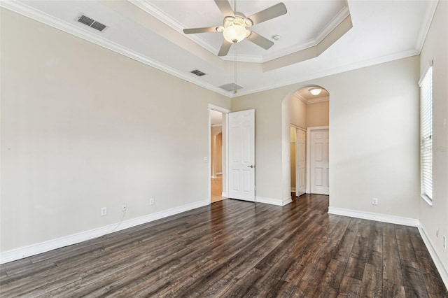 16101 Cape Coral Dr, Wimauma, FL 33598 - unfurnished room featuring arched walkways, dark wood-style flooring, ceiling fan, a raised ceiling, and baseboards