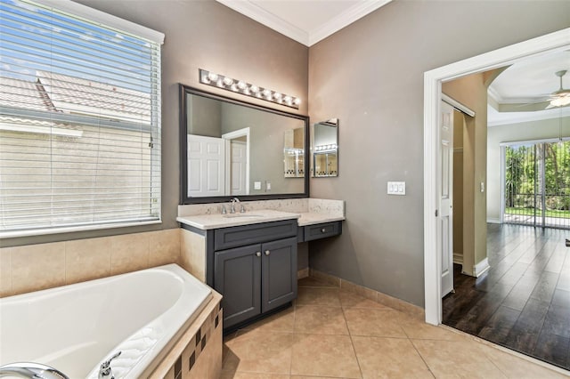 16101 Cape Coral Dr, Wimauma, FL 33598 - bathroom featuring crown molding, ceiling fan, a garden tub, baseboards, and vanity