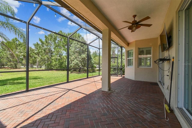 16101 Cape Coral Dr, Wimauma, FL 33598 - unfurnished sunroom featuring a ceiling fan and view of scattered trees