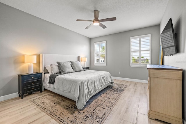 11322 Lake Lucaya Dr, Riverview, FL 33579 - bedroom featuring light wood-style flooring, baseboards, ceiling fan, and a textured ceiling