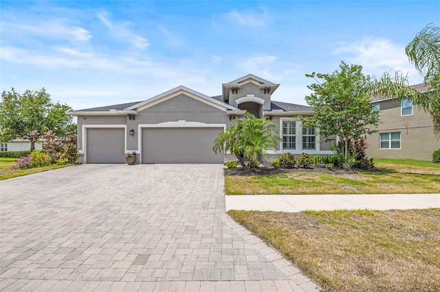 11322 Lake Lucaya Dr, Riverview, FL 33579 - ranch-style home featuring a garage, decorative driveway, stucco siding, and a front yard