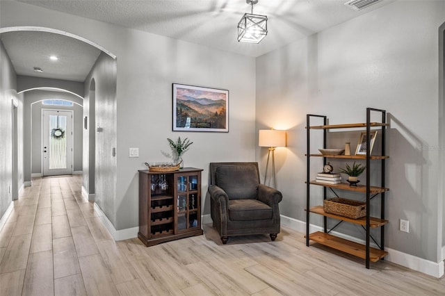11322 Lake Lucaya Dr, Riverview, FL 33579 - living area featuring arched walkways, wood finished floors, and baseboards