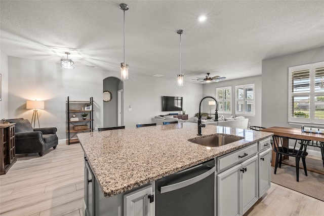 11322 Lake Lucaya Dr, Riverview, FL 33579 - kitchen with open floor plan, a sink, stainless steel dishwasher, a ceiling fan, and a textured ceiling
