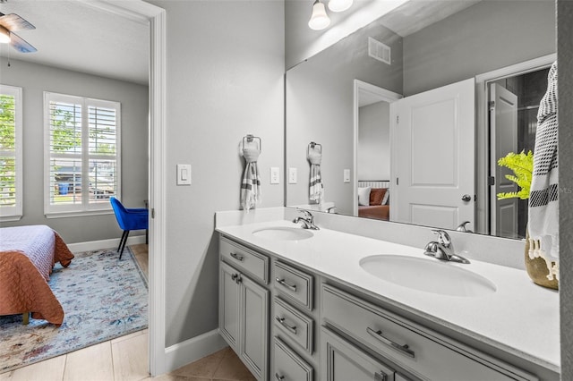 11322 Lake Lucaya Dr, Riverview, FL 33579 - bathroom with ensuite bathroom, double vanity, baseboards, tile patterned flooring, and ceiling fan