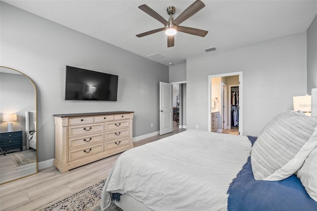 11322 Lake Lucaya Dr, Riverview, FL 33579 - bedroom featuring light wood-type flooring, baseboards, ceiling fan, and connected bathroom