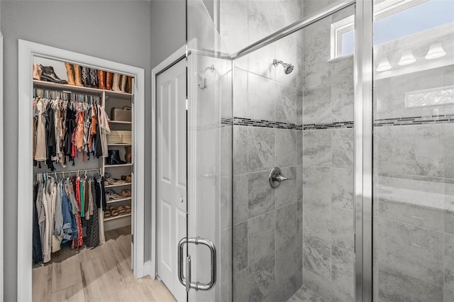 11322 Lake Lucaya Dr, Riverview, FL 33579 - bathroom featuring wood finished floors, a shower stall, and a walk in closet