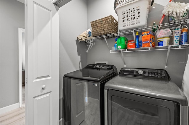 11322 Lake Lucaya Dr, Riverview, FL 33579 - laundry room featuring washer and dryer, baseboards, and wood finished floors