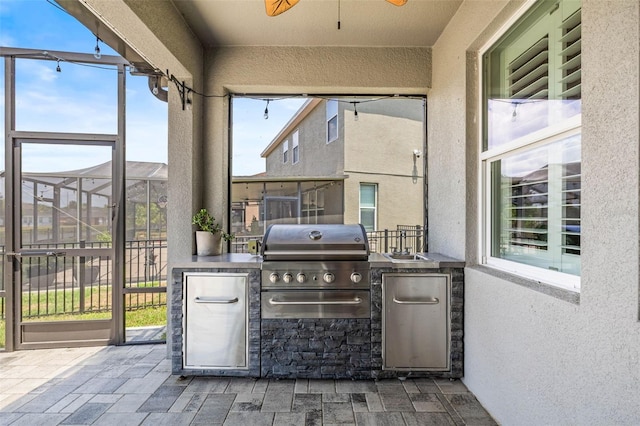 11322 Lake Lucaya Dr, Riverview, FL 33579 - view of patio featuring an outdoor kitchen, ceiling fan, grilling area, and glass enclosure