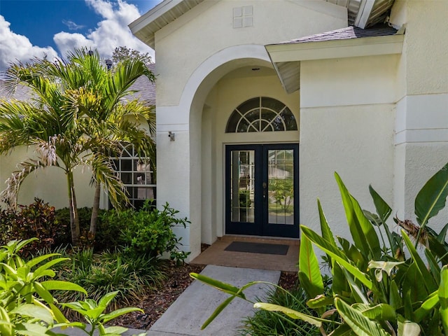 4612 River Overlook Dr, Valrico, FL 33596 - view of exterior entry featuring french doors and stucco siding