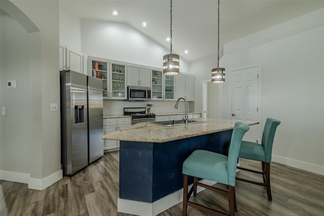 4612 River Overlook Dr, Valrico, FL 33596 - kitchen with stainless steel appliances, a center island with sink, dark wood-style floors, white cabinetry, and high vaulted ceiling