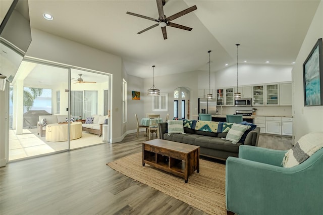 4612 River Overlook Dr, Valrico, FL 33596 - living room featuring a ceiling fan, recessed lighting, arched walkways, wood finished floors, and high vaulted ceiling