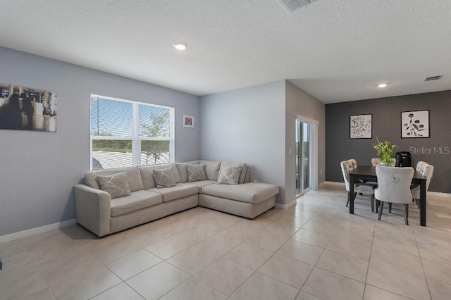 9532 Black Walnut Dr, Clermont, FL 34715 - living room with a textured ceiling, recessed lighting, light tile patterned floors, and baseboards