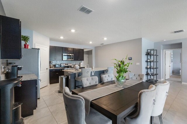 9532 Black Walnut Dr, Clermont, FL 34715 - dining room featuring light tile patterned floors and recessed lighting