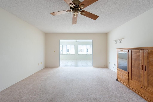 106 Silverbell Ct, Sun City Center, FL 33573 - unfurnished living room with carpet flooring, a ceiling fan, and a textured ceiling