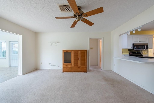 106 Silverbell Ct, Sun City Center, FL 33573 - unfurnished living room with a ceiling fan, light colored carpet, and a textured ceiling