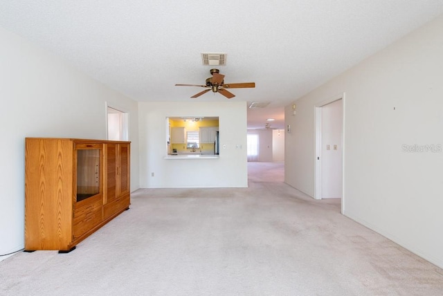 106 Silverbell Ct, Sun City Center, FL 33573 - unfurnished living room featuring light colored carpet and a ceiling fan