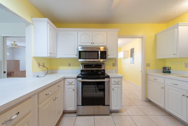 106 Silverbell Ct, Sun City Center, FL 33573 - kitchen featuring stainless steel appliances, a ceiling fan, white cabinetry, light countertops, and light tile patterned floors
