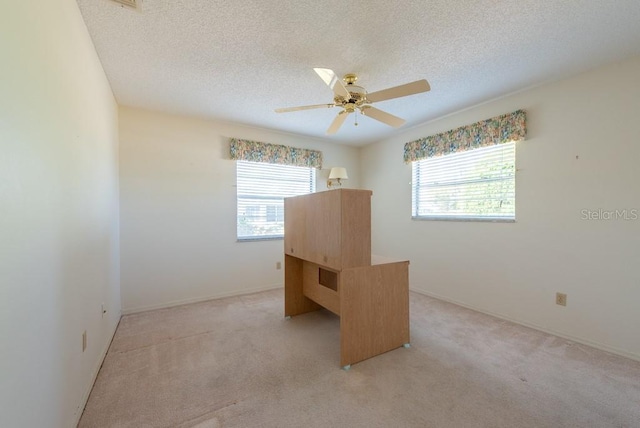 106 Silverbell Ct, Sun City Center, FL 33573 - unfurnished bedroom with light carpet, a textured ceiling, ceiling fan, and baseboards
