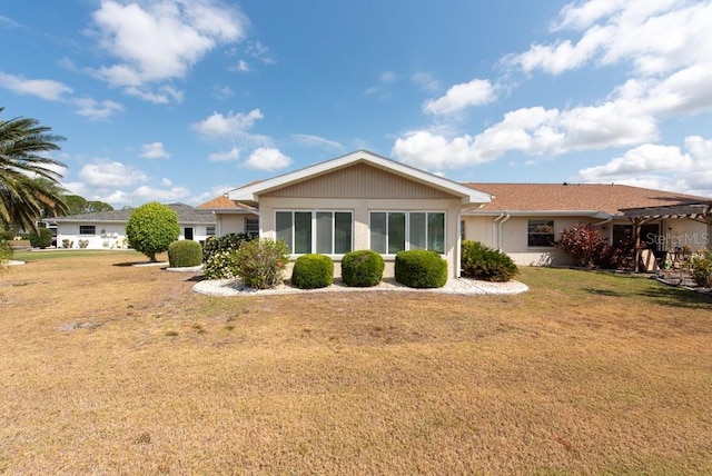 106 Silverbell Ct, Sun City Center, FL 33573 - back of house featuring a lawn