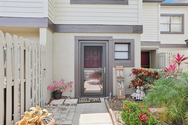 330 Woods Landing Trl, Oldsmar, FL 34677 - doorway to property with fence and stucco siding