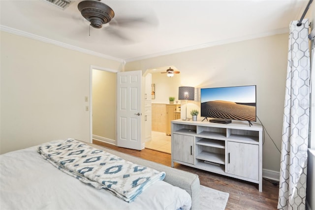 330 Woods Landing Trl, Oldsmar, FL 34677 - bedroom with ornamental molding, arched walkways, wood finished floors, connected bathroom, and a ceiling fan