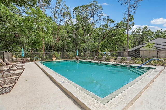 330 Woods Landing Trl, Oldsmar, FL 34677 - community pool featuring fence, view of scattered trees, and a patio area