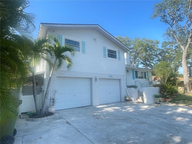 6073 115th Ave N, Pinellas Park, FL 33782 - view of side of property with a garage and driveway