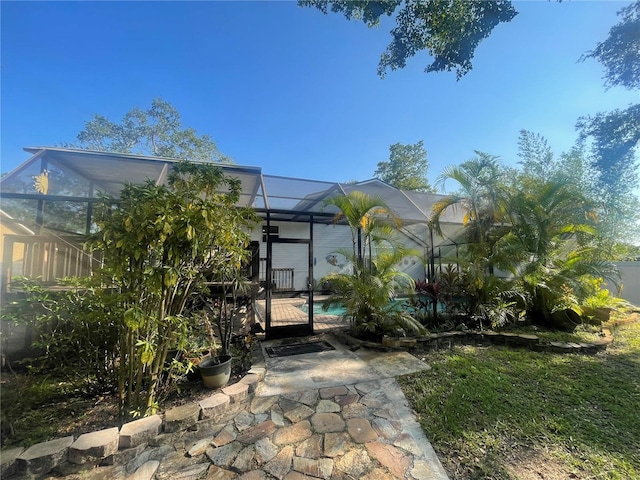 6073 115th Ave N, Pinellas Park, FL 33782 - rear view of house featuring glass enclosure, an outdoor pool, and a patio