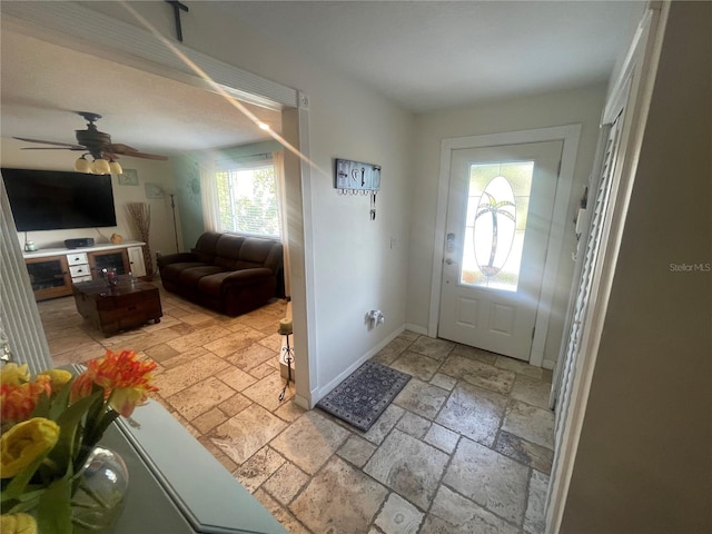 6073 115th Ave N, Pinellas Park, FL 33782 - foyer featuring stone tile floors, ceiling fan, and baseboards