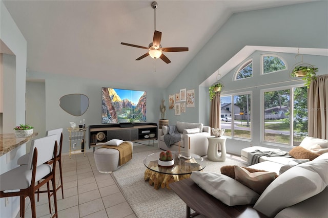 living room featuring a ceiling fan, light tile patterned floors, and high vaulted ceiling