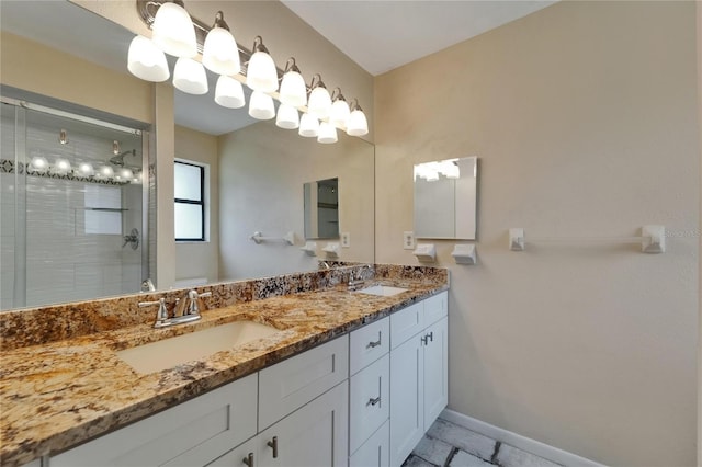 full bathroom with a stall shower, double vanity, baseboards, and tile patterned floors