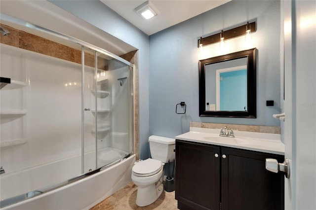 bathroom with vanity, combined bath / shower with glass door, and toilet